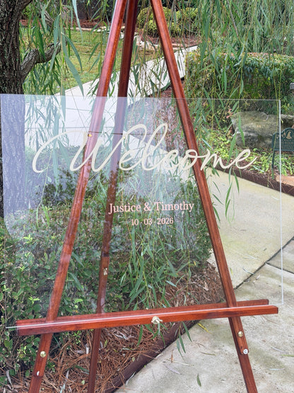 Clear acrylic wedding welcome sign with personalized names and date