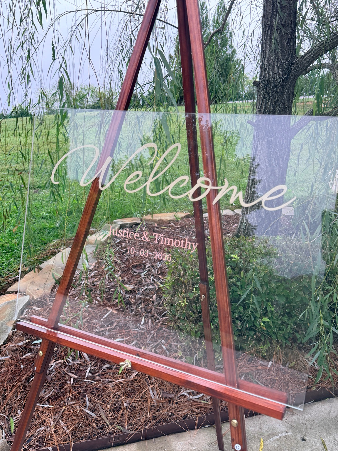 Angled view of custom clear acrylic wedding welcome sign