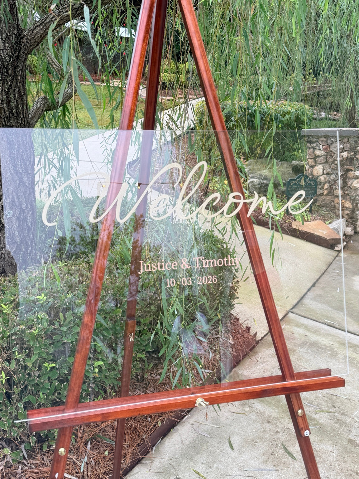 Personalized acrylic wedding welcome sign on wooden easel