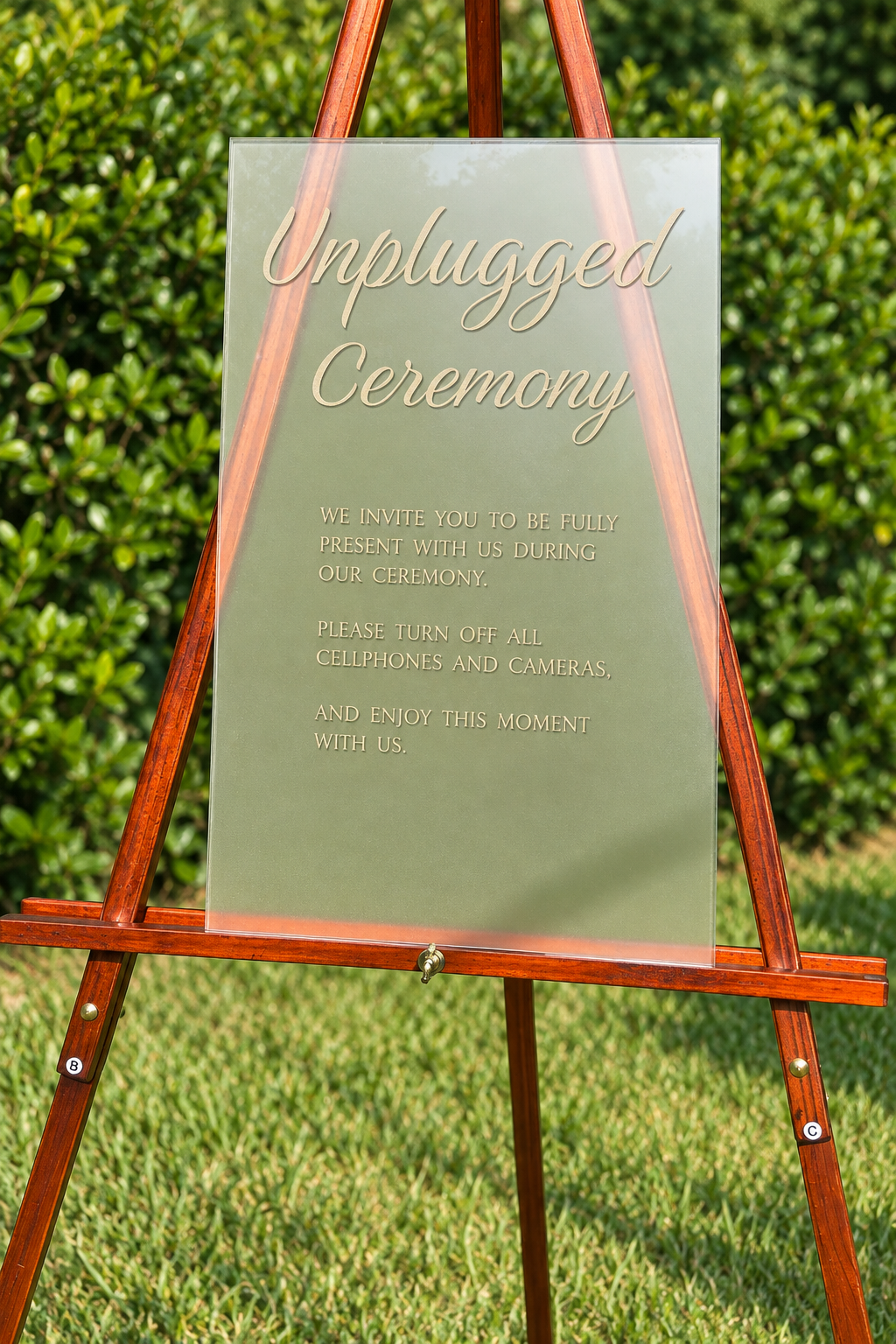 12 x 18 clear acrylic Unplugged Ceremony wedding sign, reverse engraved and reverse paint-filled, displayed on a wooden easel
